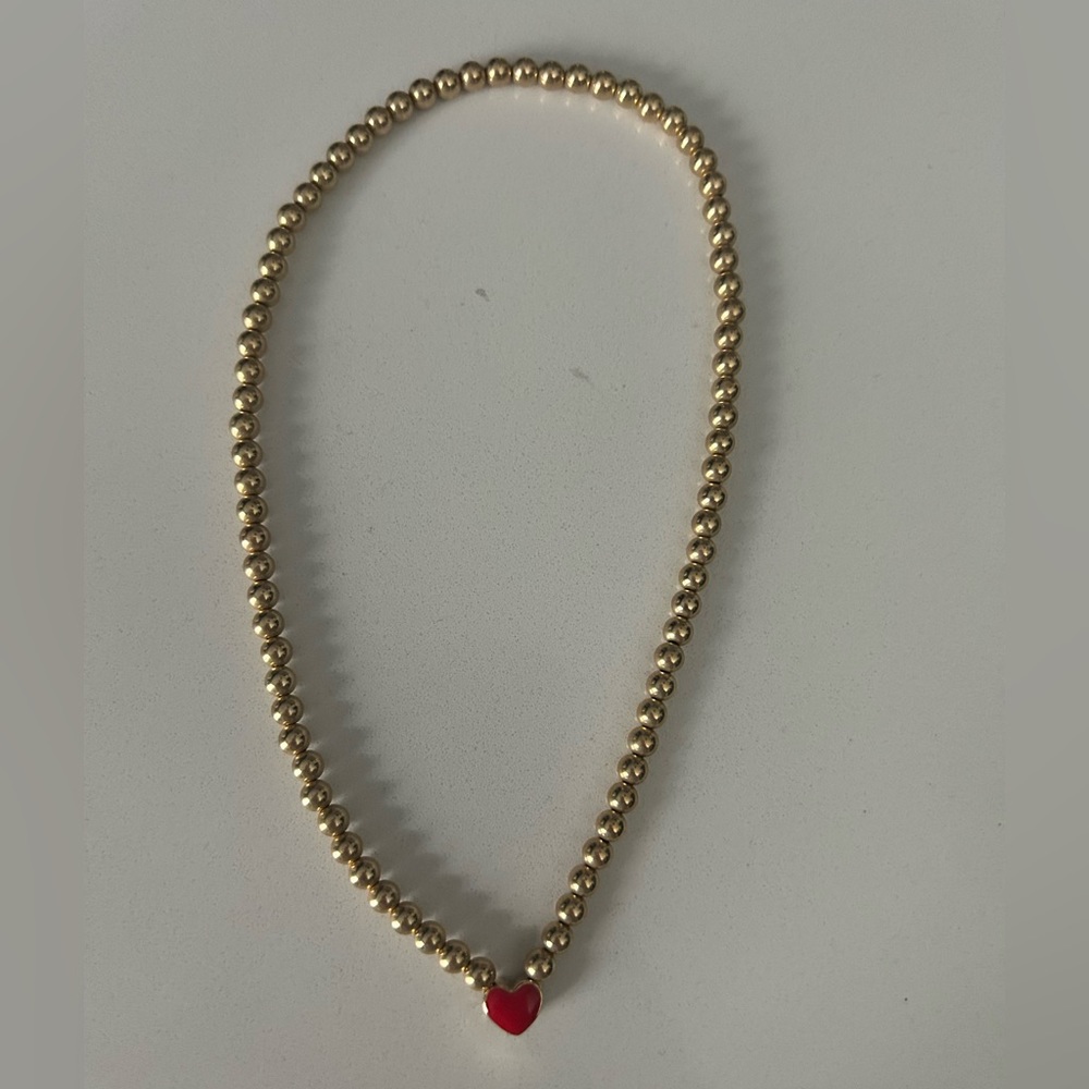 Alexa Leigh necklace. One side red heart other side blue. Good condition